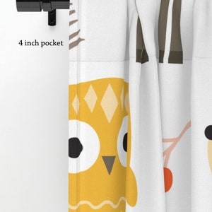 May include: A pair of white curtains featuring a yellow owl, brown tree, and red berry design. The curtains have a 4 inch pocket at the top for a curtain rod.