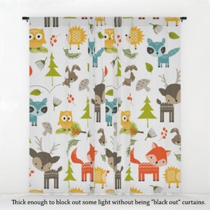 May include: White curtains featuring a repeating pattern of woodland animals, including owls, deer, foxes, raccoons, and hedgehogs. The animals are illustrated in a colourful cartoon style against a white background.