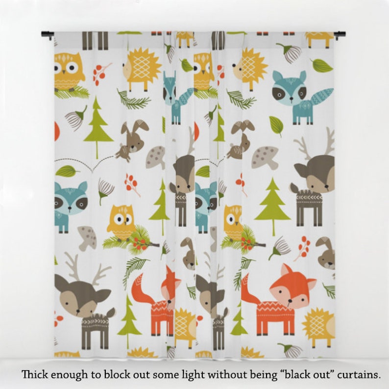 May include: White curtains featuring a repeating pattern of woodland animals, including owls, deer, foxes, raccoons, and hedgehogs. The animals are illustrated in a colourful cartoon style against a white background.