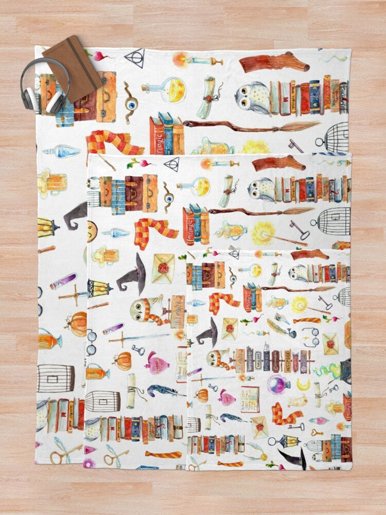 May include: White fabric with a repeating pattern of watercolor illustrations of magical objects, including books, owls, wands, potions, and keys. The pattern is in shades of brown, orange, yellow, blue, green, and purple.