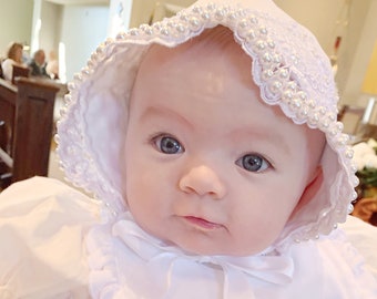 White elegant satin and lace baby bonnet with hand sewn double row of pearls