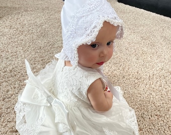 White elegant satin and lace baby bonnet with hand sewn double row of pearls