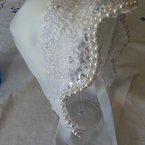 White elegant satin and lace baby bonnet with hand sewn double row of pearls