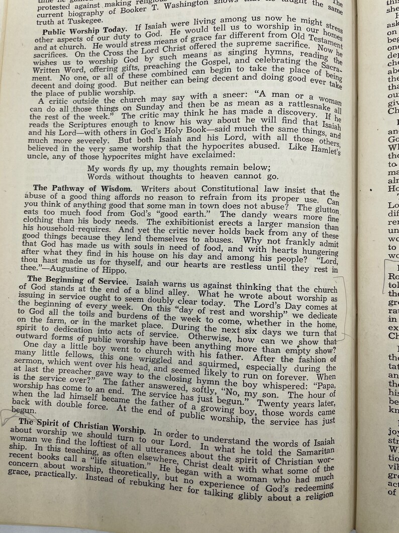 May include: A black and white page from a book with text about public worship and the importance of service. The text includes quotes from Isaiah and Augustine of Hippo.
