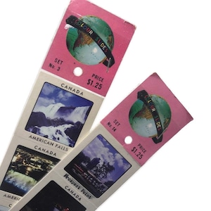 May include: Two pink and white cardboard cards with a globe graphic and the text "COLOUR SLIDES". The cards have images of Niagara Falls and Prospect Point in Canada. The text "SET No. 3" and "PRICE $1.25" are on the top card. The text "SET No. 14" and "PRICE $1.25" are on the bottom card.