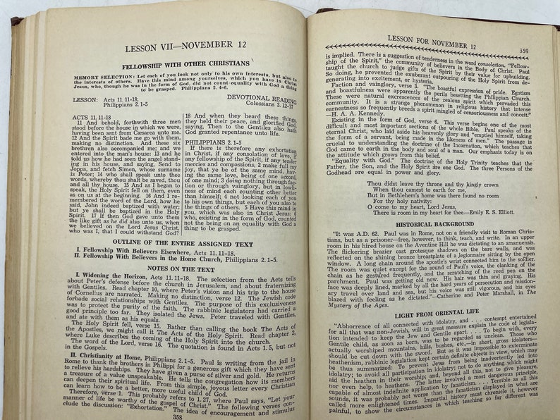 May include: A vintage, open book with yellowed pages, showing a lesson on fellowship with other Christians. The text includes scripture verses from Acts and Philippians, discussing the importance of unity and love within the Christian community.