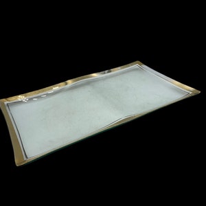 May include: A clear glass serving tray with a gold rim. The tray is rectangular and has a slightly wavy edge.
