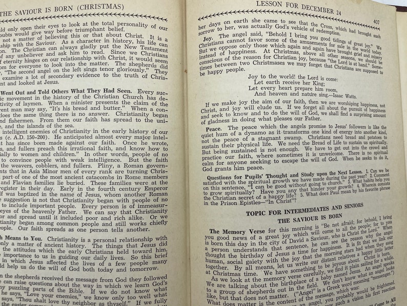 May include: A vintage book with a yellowed page open to a lesson about the birth of Jesus Christ. The text includes the words "The Saviour is Born" and "Lesson for December 24".