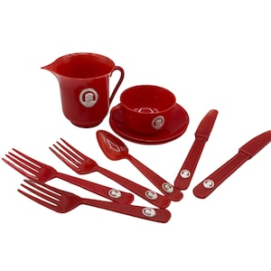 May include: A red plastic children's tea set with a teapot, cup, saucer, spoon, and forks. The set features a white embossed design.