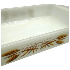 May include: Rectangular white baking dish with a wheat stalk design in shades of brown and gold. The dish has a smooth, glossy finish and is suitable for baking and serving.