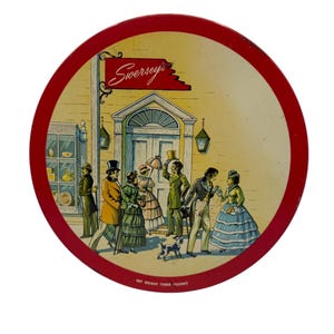 May include: A vintage round tin with a red border and a yellow background. The tin features a storefront with a sign that reads "Swersey's". There are people in 19th-century clothing walking in front of the store. The text at the bottom reads "Net Weight Three Pounds".
