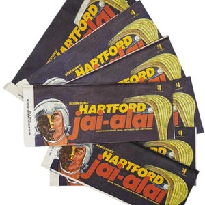 May include: A collection of vintage Hartford Jai-Alai event programs. The programs feature a dark background with the words "HARTFORD Jai-Alai" in large yellow and red letters. The programs also include an illustration of a player and a cesta.