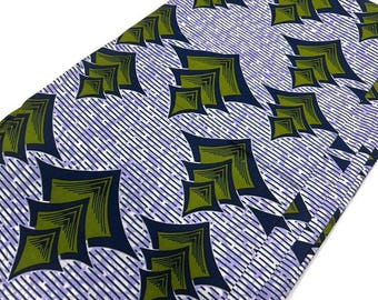 May include: A fabric with a geometric pattern of green, blue, and white. The pattern is made up of overlapping squares and triangles.