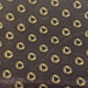 May include: Black fabric with a repeating pattern of white and yellow swirls. The fabric is covered in tiny white dots.