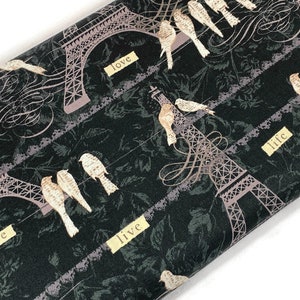 May include: Black fabric with a repeating pattern of the Eiffel Tower, birds, and the words "love", "life", and "live".