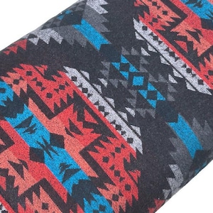 May include: Black fabric with a geometric pattern in shades of red, blue, and gray. The pattern is reminiscent of Native American designs.