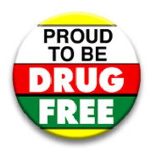 May include: A yellow, red, and green button with the text "PROUD TO BE DRUG FREE" in black letters.