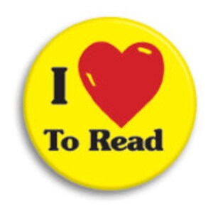 May include: Yellow button with a red heart and the text "I love to read" in black.