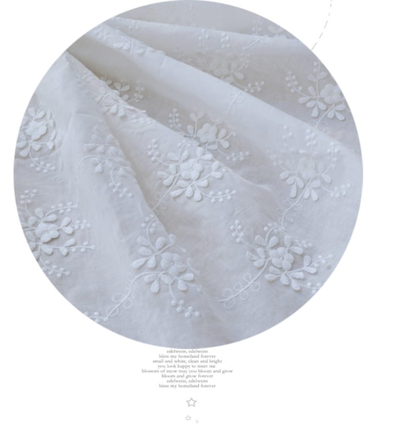 May include: White cotton fabric featuring a delicate floral embroidery pattern. The fabric is sheer and lightweight, with a soft, flowing texture.