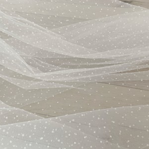 Off white tulle fabric with flocking dots. white mesh with polka dots for dress, prop
