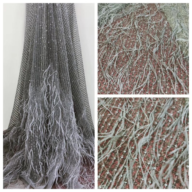 May include: Gray tulle fabric with silver sequins and white feather trim. The fabric is soft and delicate, and the feathers add a touch of elegance.