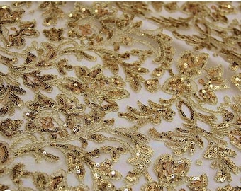 May include: Gold sequined fabric with a floral pattern. The sequins are small and closely spaced, creating a shimmering effect.