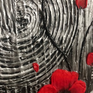 May include: Textured abstract art piece with a silver and black background. Red poppy flowers are featured in the foreground. The artwork has a 3D effect, with raised textures and a close-up view.