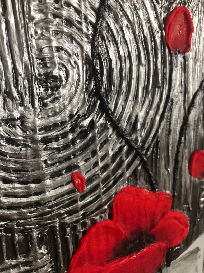 May include: Textured abstract art piece with a silver and black background. Red poppy flowers are featured in the foreground. The artwork has a 3D effect, with raised textures and a close-up view.