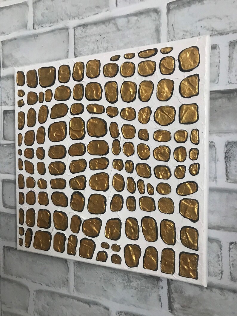 May include: Abstract painting on canvas with a white background and gold textured circles. The circles are arranged in a pattern resembling scales.