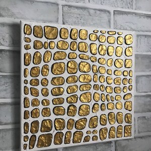 May include: Abstract painting on canvas with a textured gold and white design. The gold paint is raised and creates a pattern of overlapping circles.