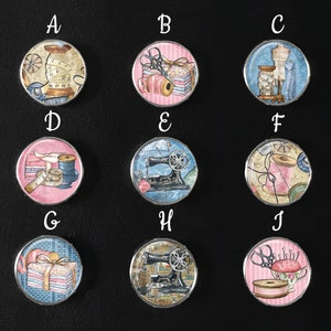 May include: Ten round, silver-rimmed, glass cabochons with various sewing-themed images. The images include a spool of thread, a sewing machine, a stack of fabric, and a thimble.