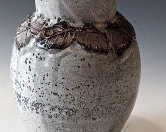 gray vase with leafy wreath