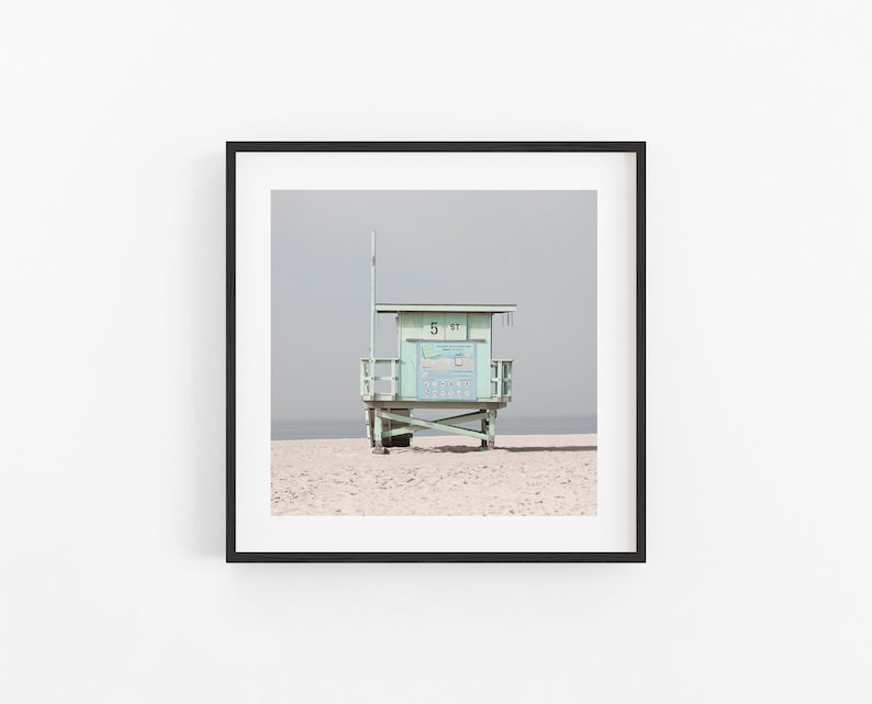 May include: A light green lifeguard stand with a white roof and a sign that reads "5 31" on a sandy beach.
