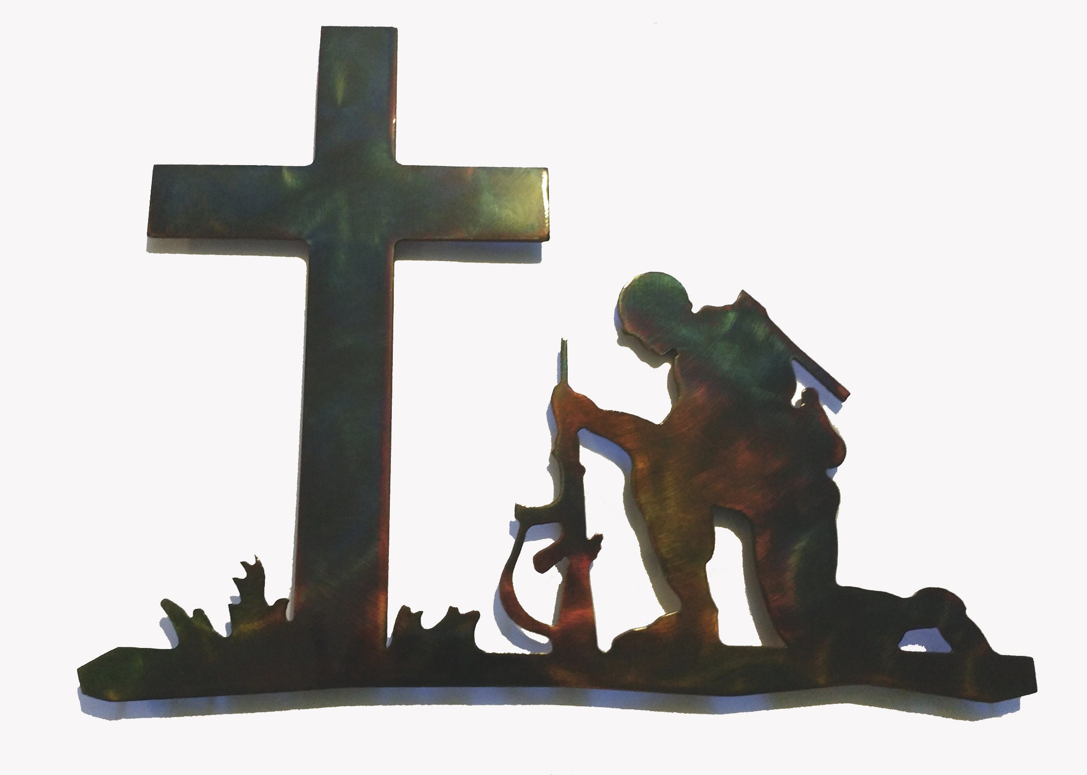 soldier kneeling at cross statue