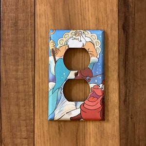 May include: A light blue, white, and red light switch cover featuring a cartoon image of King Triton from Disney's The Little Mermaid.  The cover has two standard outlet openings.