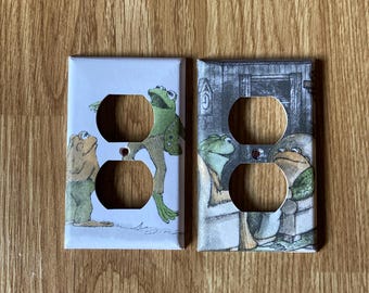 Tapas para enchufes eléctricos con forma de rana y sapo, hechas con materiales reciclados.