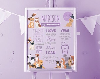 May include: A purple and white first birthday milestone poster with a dog theme. The poster features a dog illustration and the text "Madison, My First Birthday". The poster also includes information about the child's age, favorite foods, and abilities.