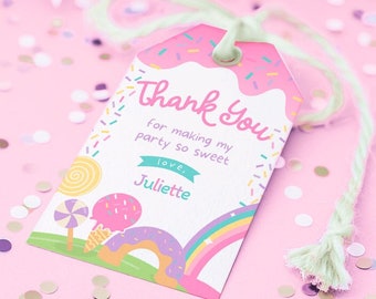 May include: A pink and white gift tag with a donut design at the top and the words "Thank You" in pink script. The tag includes the text "for making my party so sweet, love, Juliette" and a candy-themed illustration. The tag is tied with green string.