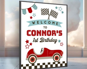 May include: Welcome to Connor's 1st Birthday party sign with a red toy car, checkered flag, and stars. The sign is white with red, blue, and black accents.