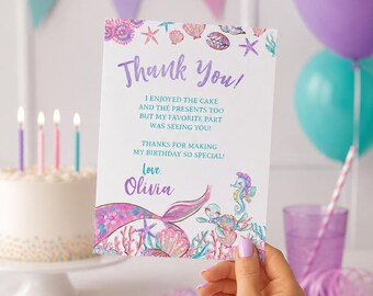 May include: A birthday thank you card held by a person. The card features a mermaid tail and seahorse illustration with the words "Thank You!" and a personalized message. The background includes a cake, balloons, and confetti.