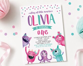 May include: A white birthday invitation card featuring the text "calling all little monsters OLIVIA IS TURNING one" in purple, pink, and teal. The card includes colorful monster illustrations and event details for Saturday, November 30th.