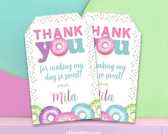 May include: Two pink and white thank you tags with a donut graphic and the text "Thank you for making my day so sweet! Love, Mila". The tags are decorated with colorful sprinkles.