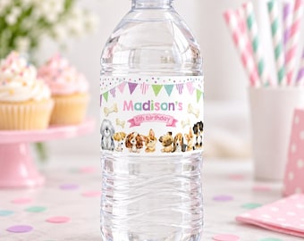 May include: A clear plastic water bottle with a custom label featuring colorful bunting, bone illustrations, and the text Madison's 5th birthday. The label displays a row of various illustrated dog breeds in a watercolor style on a white background.
