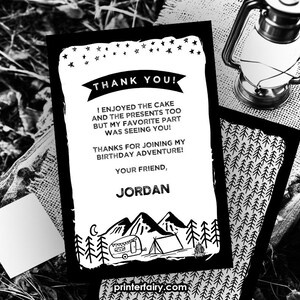 May include: Black and white thank you card with a camping theme. The card features a camper, tent, and campfire. The text on the card reads "Thank You! I enjoyed the cake and the presents too but my favorite part was seeing you! Thanks for joining my birthday adventure! Your friend, Jordan."