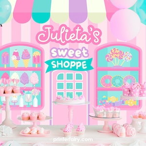 May include: A pink and blue themed party backdrop with the text "Julieta's Sweet Shoppe" and a display of cupcakes, donuts, ice cream, and candy.