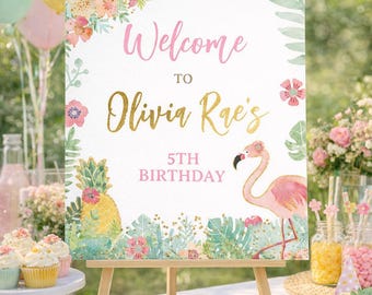May include: A wooden easel displays a welcome sign for a 5th birthday party. The sign features floral and tropical illustrations, with the text "Welcome to Olivia Rae's 5th Birthday" in pink and gold. A flamingo and pineapple are also featured.