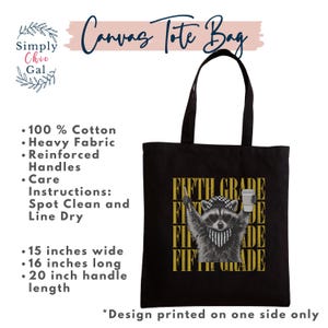 May include: A black canvas tote bag measuring 15 inches wide and 16 inches long with 20 inch handles. The bag features a graphic of a raccoon wearing a checkered cap, heart-shaped sunglasses, and a bandana, holding a pencil and a coffee cup.
