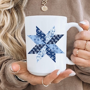 May include: White ceramic mug with a blue and white patchwork star design.