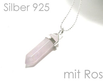 May include: A silver chain necklace with a rose quartz pendant. The pendant is shaped like a long, thin point. The text "Kette Silber 925 mit Rosenquarz" is visible in the image.