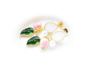 May include: A pair of gold earrings with pink and green enamel flowers and white pearl accents.